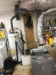 A utility room with HVAC furnace, ductwork, and water heater installation by Caballero's A/C & Heating in Marrero, LA.