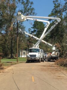 A BESCO utility truck with a bucket lift working on power lines and trees in Knoxville, TN.