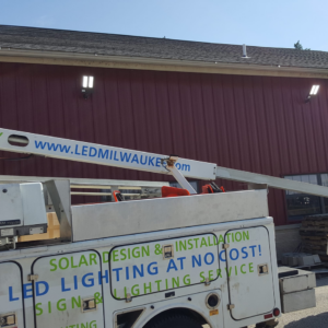A utility truck from LMS Energy installing exterior LED lighting on a building in Milwaukee, WI.