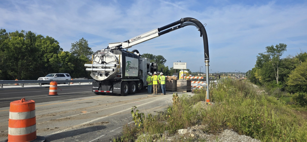 A vacuum excavator truck with its arm extended, used by TC Electric, Inc for underground electrical utility work in Indianapolis, IN.