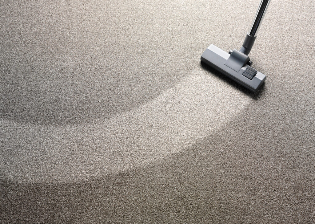A vacuum cleaner head showing a clean path on a carpet during a cleaning service by Baymist Carpet Cleaning & Repair in Spokane, WA.