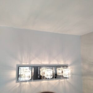 A stylish vanity light fixture with three glass shades installed by J3 Services in Goose Creek, SC.