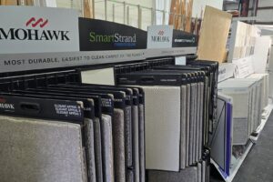 A wide variety of carpet samples displayed on racks in the showroom of M&S Flooring Inc. in Ardmore, TN.