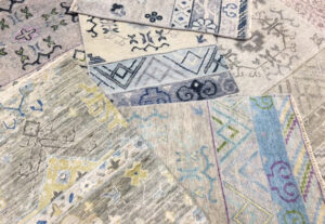 An overhead view of various rug samples displaying different patterns and textures available from Dallas Rugs in Dallas, TX.