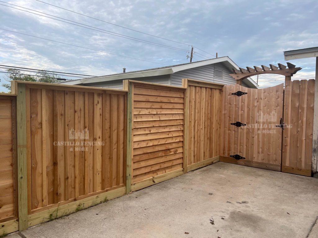 An outdoor area featuring various wood fence styles and a gate by Castillo Fencing & More in Corpus Christi, TX.