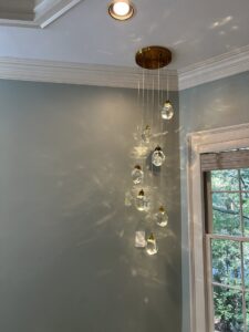 Vertical pendant light with multiple crystal drops installed by Perfection Lighting, Design, and Installations in Atlanta, GA.