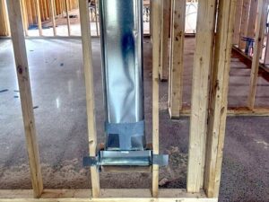 Vertical rectangular ductwork installed within wall framing by QC Mechanical, Inc. in Lockport, NY.