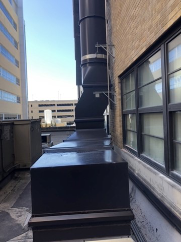 Vertical HVAC ductwork installation extending up the side of a building by Kuhlmann Supply Company in Earth City, MO