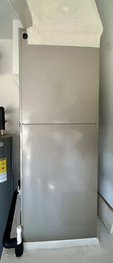 A vertical indoor HVAC air handler unit, installed or maintained by Blue Air Heating and Cooling in Orlando, FL.