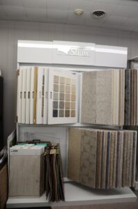 A vertical display of Shaw carpet samples in the showroom of BK The Floor Store of Nebraska in Columbus, NE.