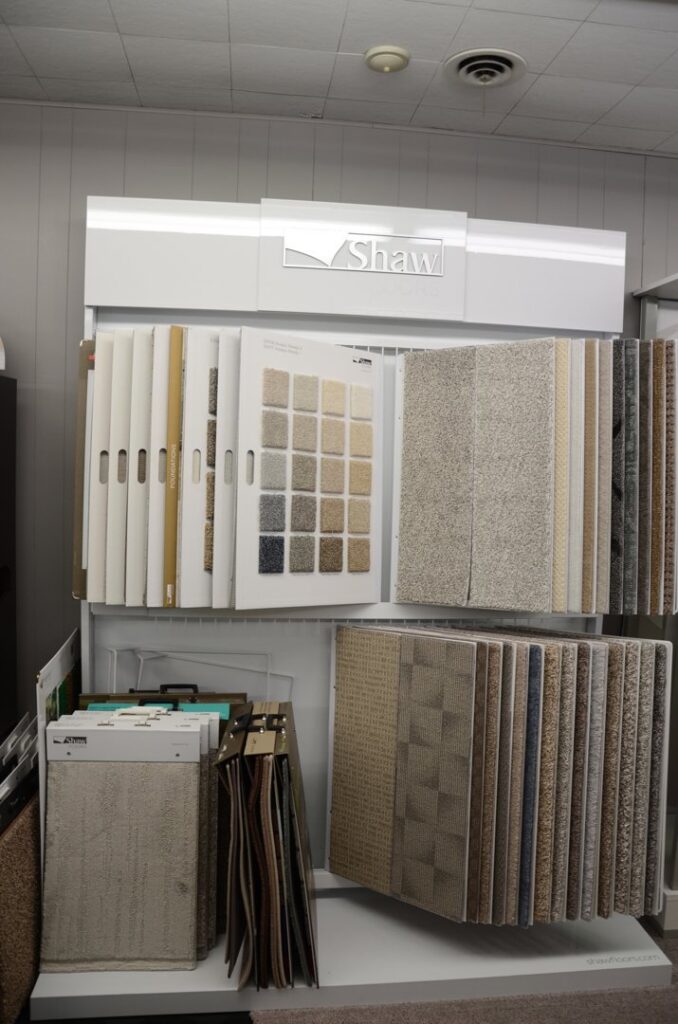 A vertical display of Shaw carpet samples in the showroom of BK The Floor Store of Nebraska in Columbus, NE.