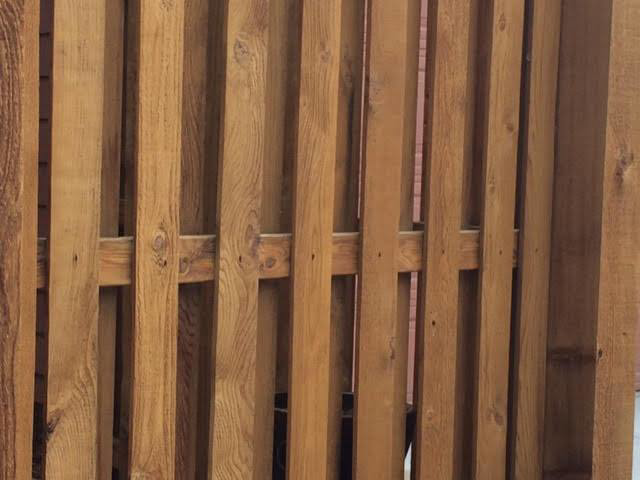 Detailed view of a vertical slat wood fence, showcasing quality craftsmanship by Colorado Fence and Gate Systems in Colorado Springs, CO.