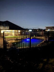 A newly installed wooden privacy fence with metal posts, captured from a vertical perspective by G L Fence & Remodeling in Arlington, TX.