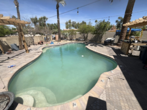 A very cloudy and green swimming pool, illustrating a pool in need of professional cleaning from Brigade Pool Services in Tempe, AZ.