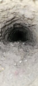 The interior of a very dirty HVAC duct, demonstrating the need for professional cleaning from Aero Brush Duct Cleaning in Billings, MT.
