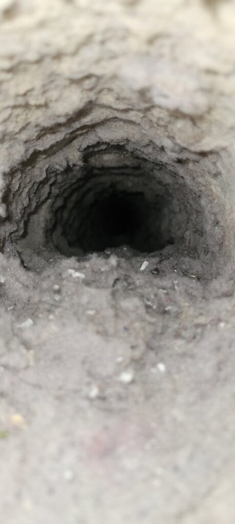 The interior of a very dirty HVAC duct, demonstrating the need for professional cleaning from Aero Brush Duct Cleaning in Billings, MT.