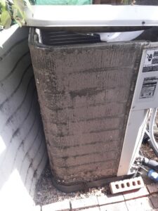 A very dirty outdoor AC coil needing service from Go West A/C & Heating in Fort Worth, TX.
