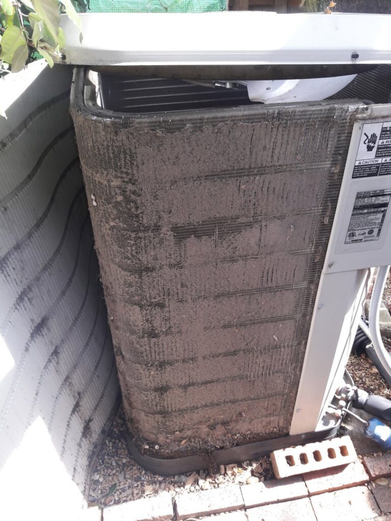 A very dirty outdoor AC coil needing service from Go West A/C & Heating in Fort Worth, TX.