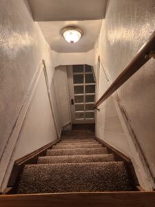 A view looking down newly carpeted stairs installed by Carpet Clearance Warehouse Pueblo, CO.