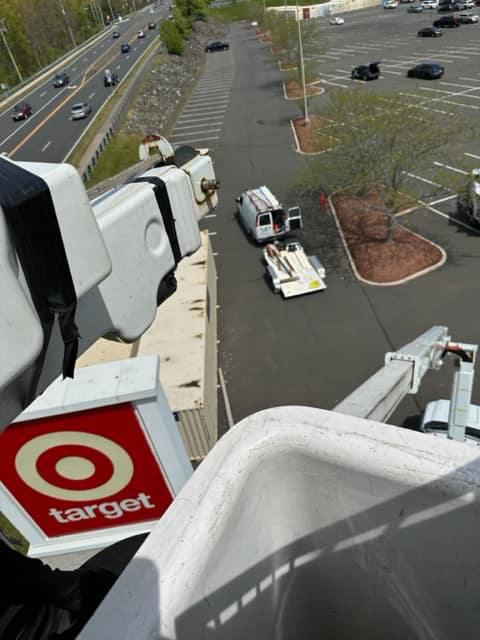 A view from a boom lift bucket overlooking a parking lot during a lighting service job by Lighting Services, Inc. in Waterbury, CT.