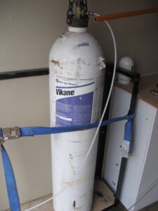 A large Vikane fumigant cylinder, essential equipment for pest control services by Valley Termite & Pest Control in Cincinnati, OH.