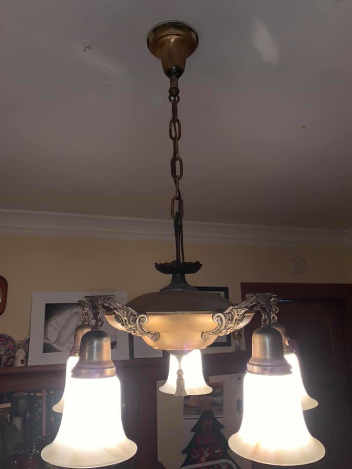 A beautiful vintage-style chandelier hanging from a ceiling, installed by Handy Hollms in Waukesha, WI