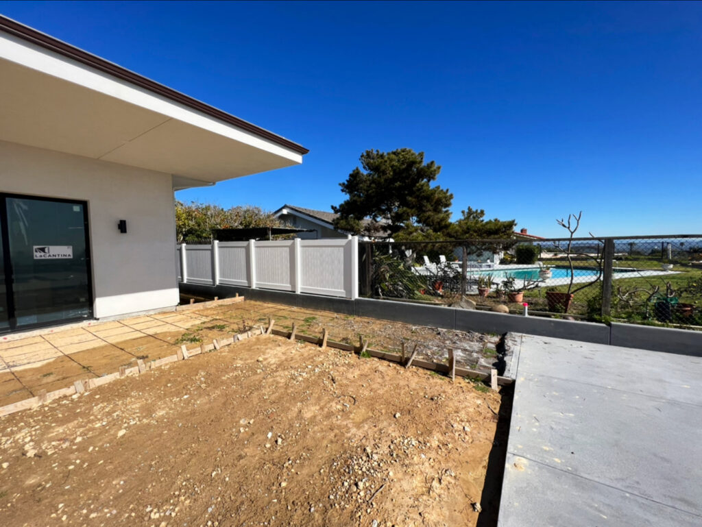 A white vinyl fence and chain-link fence installed around a pool area by Gates Access Solutions in San Diego, CA