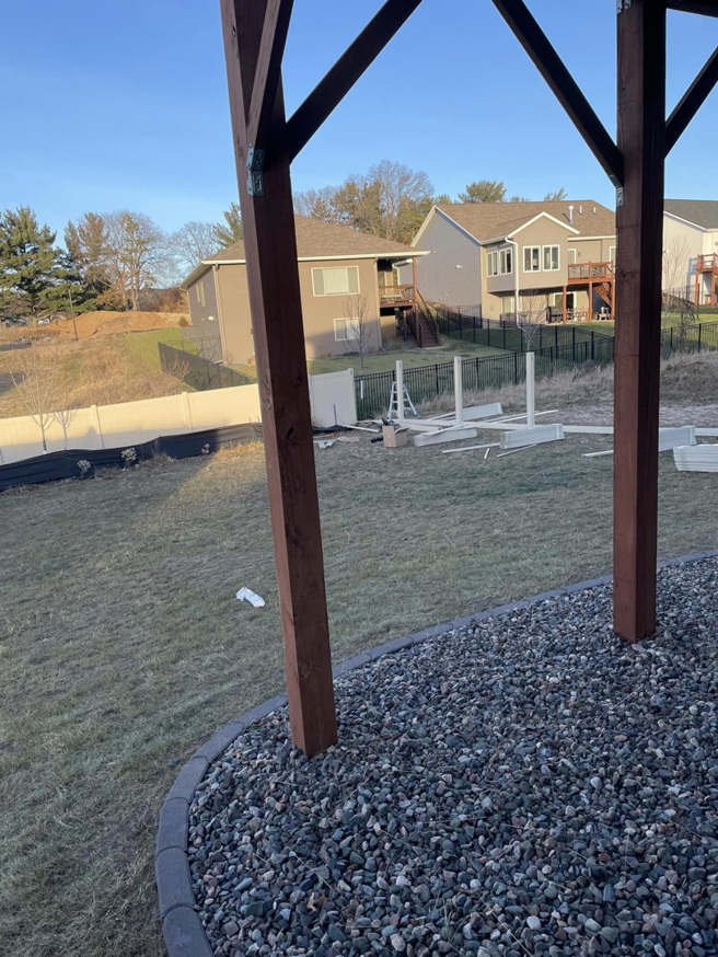 A new white vinyl fence installation in progress in a backyard by Flash Fence in Phenix City, AL.