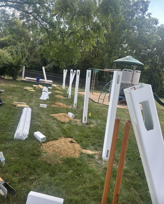 Vinyl fence posts being installed during a fencing project by Red Gate Fencing in Allentown, PA.
