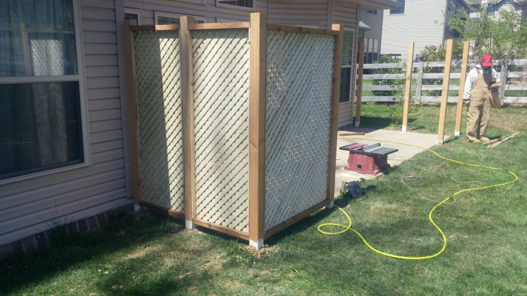 A vinyl privacy fence with a lattice top installed around a residential swimming pool by Best Fence & Gate LLC in Louisville, KY.