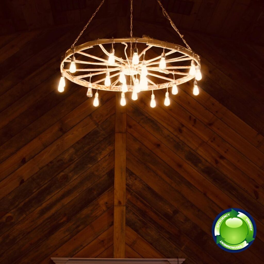 A unique wagon wheel chandelier with multiple bulbs installed by E-Systems Electrical Inc. in Cumming, GA.