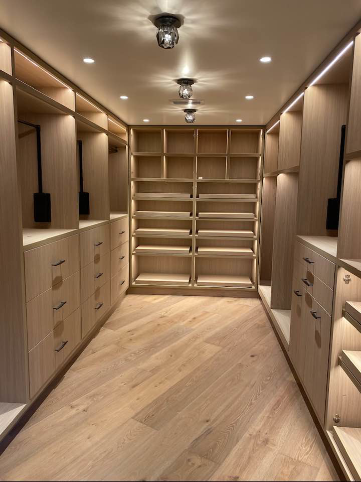 Bright walk-in closet with recessed and integrated shelf lighting installed by Kairos Electric and Construction in Anaheim, CA.
