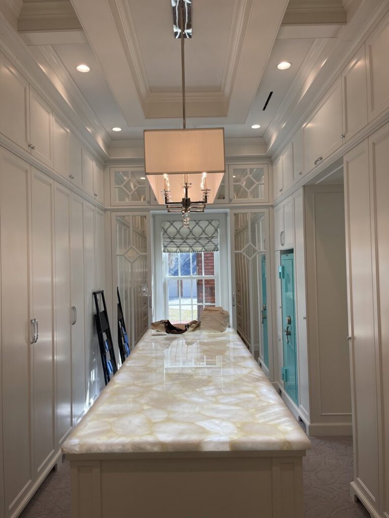 A spacious walk-in closet with recessed lighting and a stylish central fixture, installed by Johnson Electric in Port Angeles, WA.