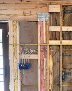 Wall electrical rough-in showing wiring and a junction box installed by Elite Electric in Valley Falls, NY