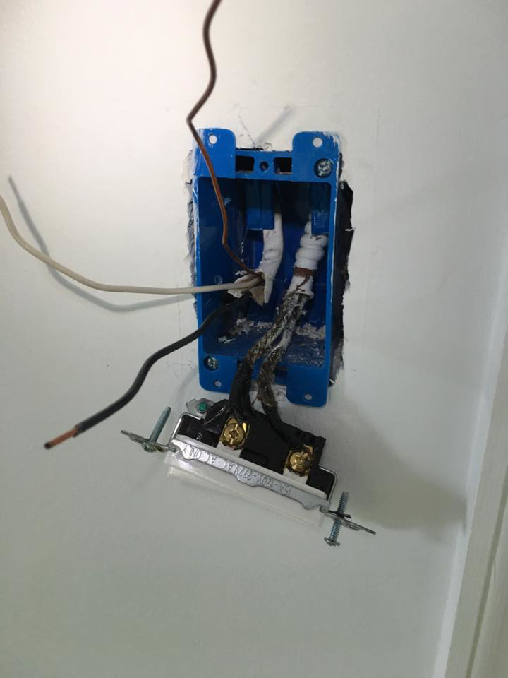 Exposed wiring and a light switch being installed in a wall by U-R Wired in Baltimore, MD.