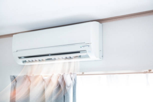 A wall-mounted split-system air conditioner unit operating, representing HVAC services by Team Mechanical, Inc in Minneapolis, MN.