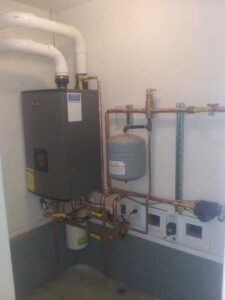 A wall-mounted boiler and heating system with copper piping installed by Boiler Man Plumbing & Heating in Palmer, AK