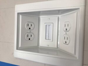 Newly installed wall-mounted electrical outlets and a cable pass-through plate by Jeremy Electrical in Roeland Park, KS.