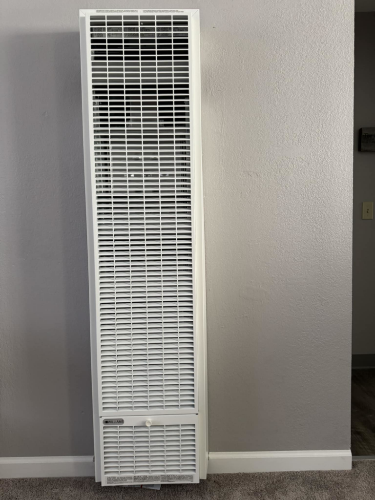 A white wall-mounted gas heater, a common HVAC unit, serviced by Torres HVAC LLC in Reno, NV.