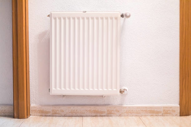 A white wall-mounted heating radiator, representing heating solutions from Infinity Heating & Cooling by Rivera in Kenosha, WI.