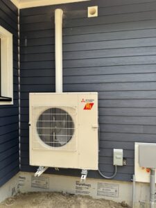 A wall-mounted Mitsubishi Electric HVAC condenser unit installed by Comfort Systems and Solutions in Coventry, RI