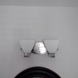 A wall-mounted light fixture with two frosted glass shades installed by J3 Services in Goose Creek, SC.