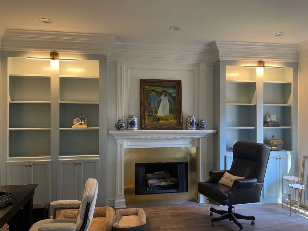New wall-mounted light fixtures installed above built-in shelves by McCurley Electric in a Little Rock, AR home.