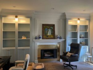 New wall-mounted light fixtures installed above built-in shelves by McCurley Electric in a Little Rock, AR home.