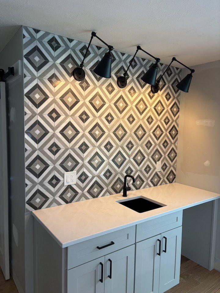 Wall-mounted light fixtures installed above a sink by Kevin Kelley Electrical Inc in Leominster, MA.