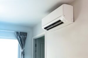 A modern wall-mounted mini-split air conditioning unit installed in a room by Shook Heating And Cooling in Livonia, MI.