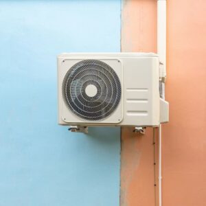 A wall-mounted mini-split air conditioning condenser unit by All The Way Heating & Cooling in Middleburgh, NY