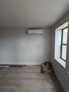 A wall-mounted mini-split indoor unit installed in a room by Inspector Rogers LLC in Draper, UT.