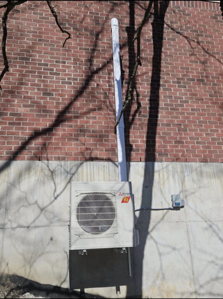A wall-mounted Mitsubishi mini-split outdoor unit installed by Pike Mechanical in Vevay, IN.