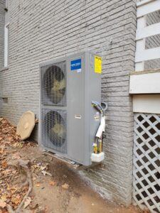 A wall-mounted MRCOOL multi-zone outdoor HVAC unit installed on a brick wall by Sizemore Heating & Air, LLC in Chapel Hill, NC